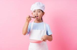 Image of Asian child practicing to be a chef photo