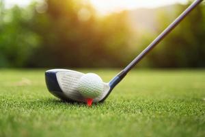 Golf ball on green grass ready to be struck photo