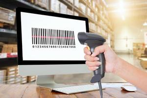 Woman scanning barcode from a label in modern warehouse photo