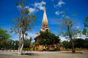 Pagoda at Chalong temple, Phuket on blue sky background photo