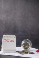 Tax return form and hand written tax date on a calendar table photo