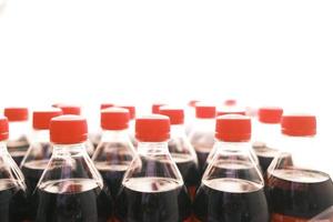 plastic bottles of soft drink on table photo