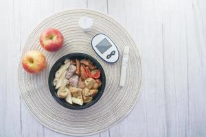 diabetic measurement tools and healthy food on table photo