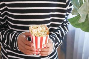 young man eating popcorn close up photo