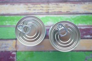 top vie of canned food on wooden background photo