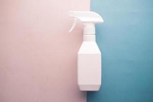 top view of white color spray bottle on color background photo