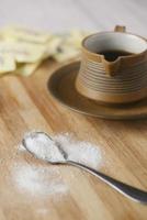 Sugar Substitute sweetener and tea cup on table photo