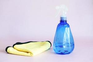 spray bottle and a cleaning cloth on table photo