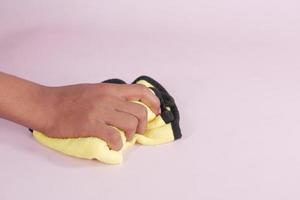 close up of person hand cleaning table with cloth photo