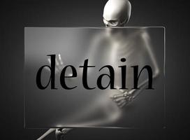detain word on glass and skeleton photo