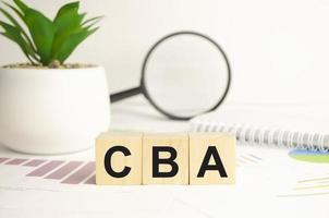CBA - letters on wooden cubes. business as usual concept image. front view photo
