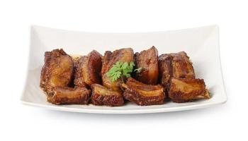 Stewed Pork and pork ribs with Spices in a plate isolated on white background with Clipping Path, Pa-Lo Thai Braised Pork Belly. photo