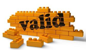 valid word on yellow brick wall photo