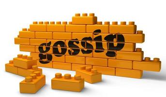 gossip word on yellow brick wall photo