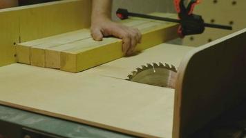 The master saws the board on a circular saw video