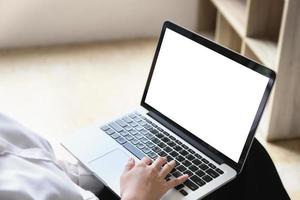 freelance concept, Woman using computers  laptop on wooden desk blur background. Laptop computer with blank screen and can be add your texts or others on screen. photo