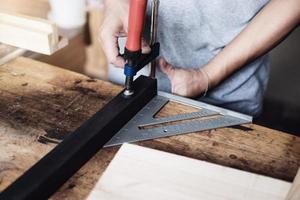 Woodworking operators are decorating pieces of wood to assemble and build wooden tables for customers. photo