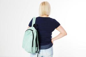 Back view of a middle-age woman with a backpack isolated over white background photo