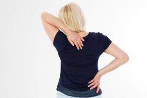 Middle-aged blonde woman with back pain isolated over white background, middle age female pain back view copy space, Female with suffering from back pain and neck pain photo