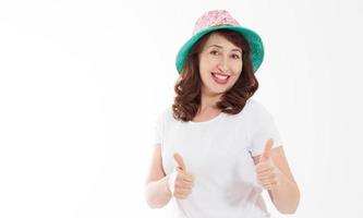 Happy surprised and excited woman in summer hat and template white t shirt show big thumb up isolated on white background. Holiday vacation with big sale. Fun summertime. Blank place on tshirt. Banner photo