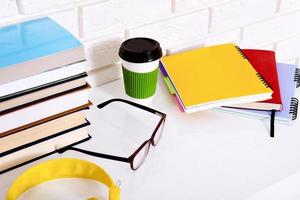 Workplace and education accessories on white table. Selective focus. Cup of coffee. Stem education