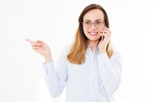 Isolated portrait of business girl with smartphone. Woman tolking on phone and points with his hand. Confident young manager. Copy space photo