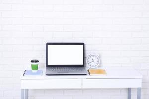 Education accessories on the table near brick wall. Empty computer and mobile screen with place for text. photo