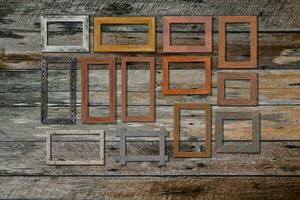 Vintage photo frames on wood wall for interior or background.