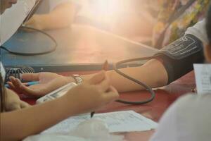 Close-up Of Female Doctor Checking Blood Pressure Of Patient. Mobile medical unit and Outpatient treatment, place photo