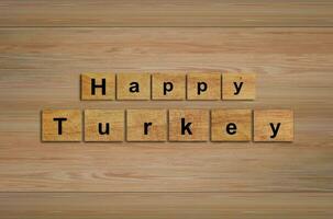 Happy Turkey day written on wood cubes. message text on wooden table for backdrop design. photo