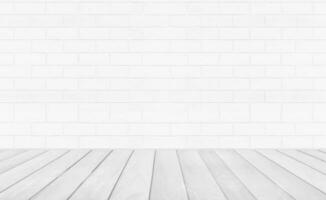 Empty room with grey wooden floor with brick wall background. Studio or office blank space. photo