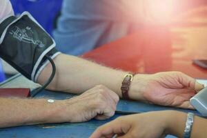 Close-up of patient arm during blood pressure measuring at medical consultation. Mobile medical unit photo