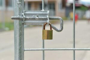 Steel fence locked with padlocks. Lock on a gate