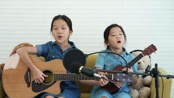 Young Girl Sisters Record While Singing and Playing Guitar in Studio video