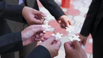 we are compatible A group of businessmen is working on puzzles together. video