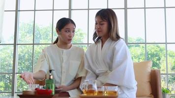 Female staff recommend spa treatment packages for young Asian women video