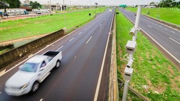 Traffic radar with speed enforcement camera in a highway. photo