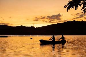 Two people rowing at sunset photo