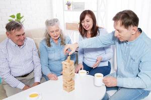 Elderly couple and elderly couple collect wooden blocks at home photo