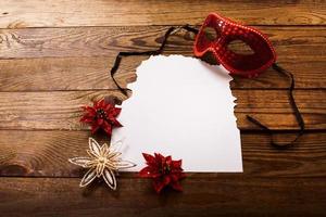 Christmas card and New Year accessories on brown wooden table. Top view. Copy space and place for text. photo