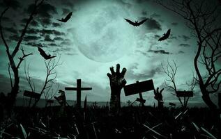 Zombie hand rising out of a grave in spooky night. Halloween concept photo