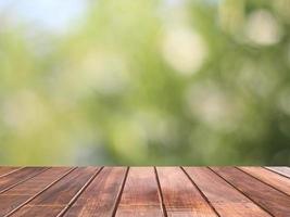 Wooden table with green bokeh is background, Wooden table top used for background photo