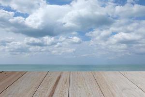 Wooden table with sea and clouds is background, Wooden table top photo