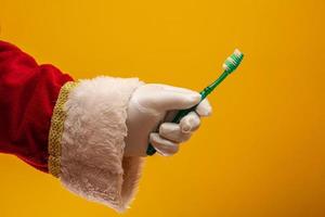 Santa Claus hand with toothbrush photo