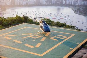 Rio de Janeiro, Brazil, OCT 2019 - Panoramic flight helicopter landing in helipad on the top of Sugarloaf Mountain, Rio de Janeiro, Brazil. photo