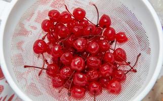 Sweet organic cherries on a sieve. Top view. photo