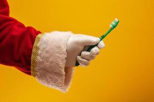 Santa Claus hand with toothbrush