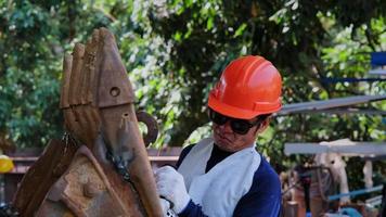 Professional men wearing goggles and construction gloves work in home workshop with angle grinder. Sanding metal makes sparks, closeup video