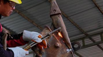 Worker cutting steel with a gas torch. Man cutting steel with propane and oxygen. Processes that use fuel gases and oxygen to weld and cut metals.