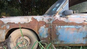 Old car or vintage car Which has peeling color and has cracked color due to the sun and rain.